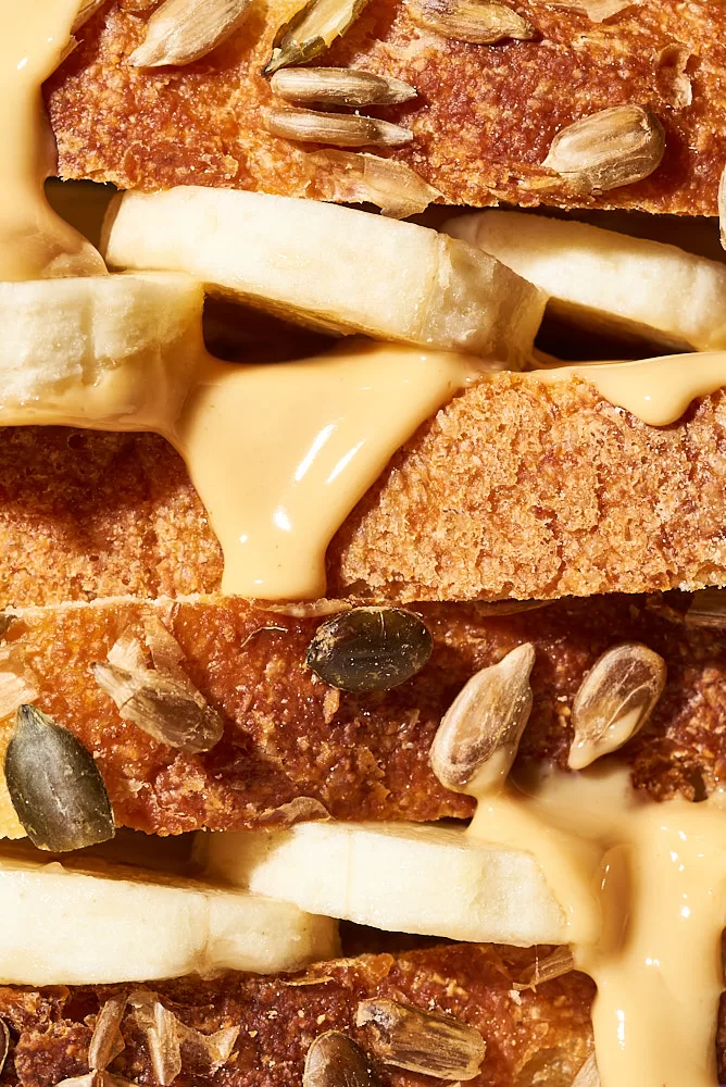 Bold macro food photography of a peanut butter and banana sandwich