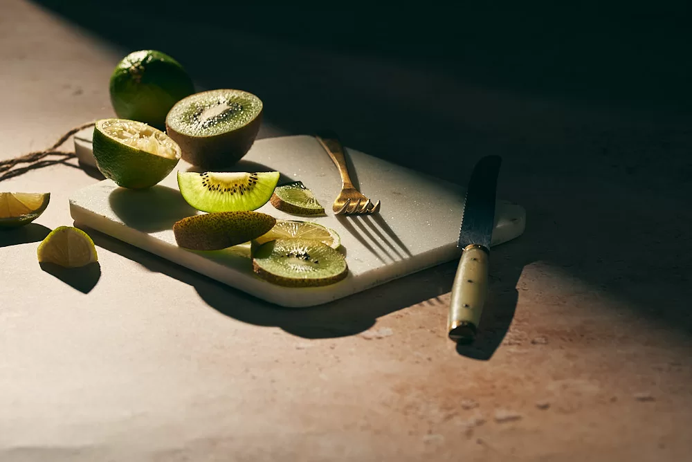 Food photography in Barcelona of kiwis in the sun. Shadow and light play in food photography