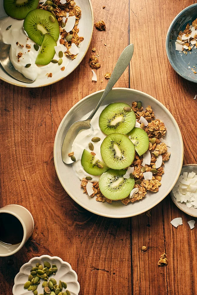 Food photography of kiwi yogurt with coconut flakes