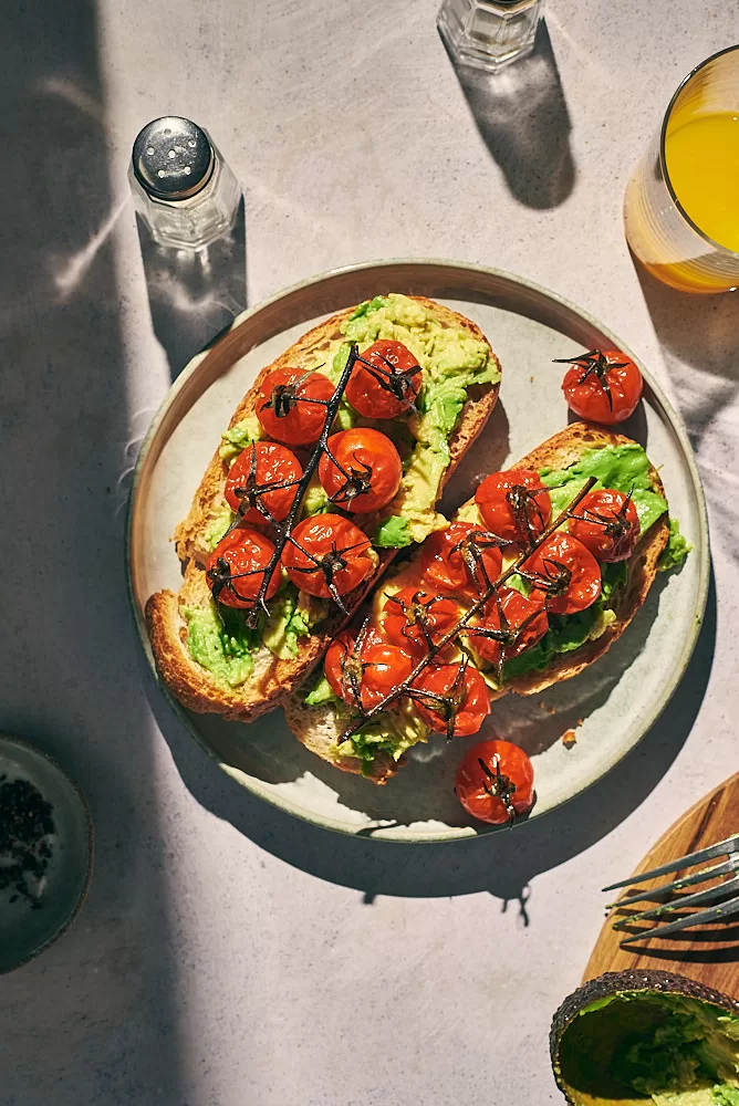 Bright, fresh, sunny and colorful food photography in Barcelona of avocado and roasted tomato toast